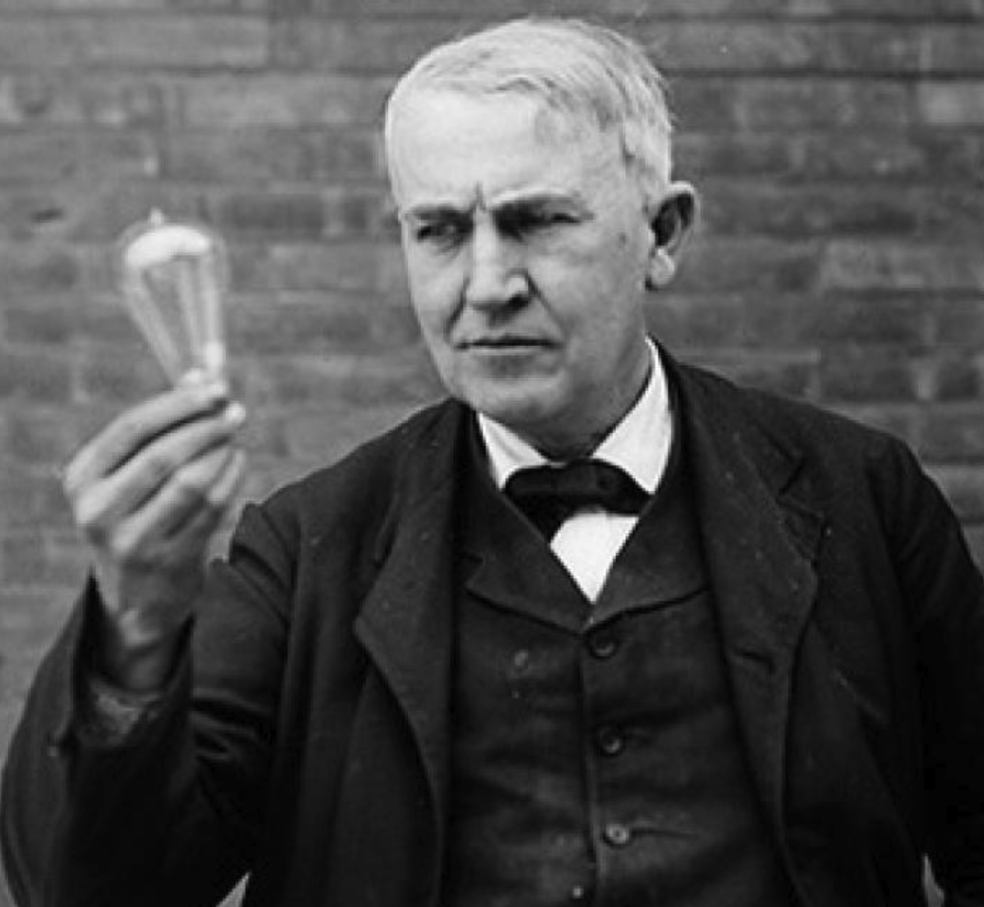 Photograph of Thomas Edison holding a lightbulb